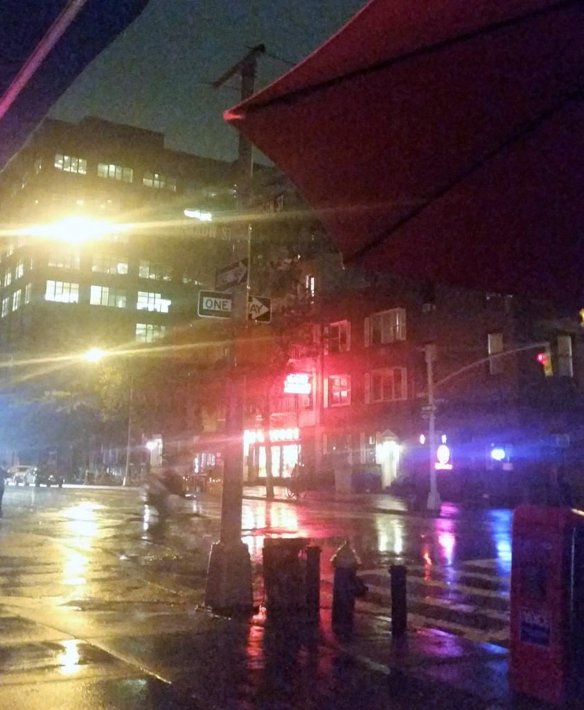 Rainy night view from a sidewalk table at Oscar's Place on Hudson Street.